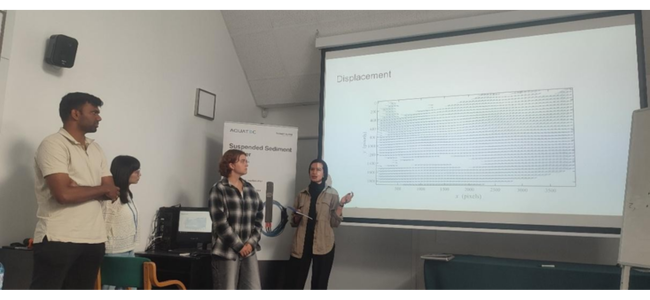 Students presenting their report for evaluation.png